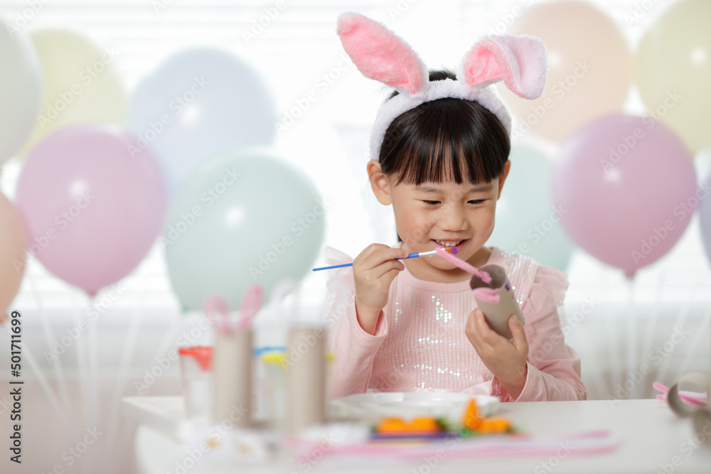 young girl making easter craft at home