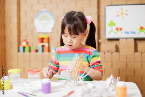 young girl hand make craft for home schooling