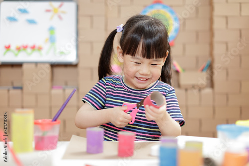 young girl making craft for homeschooling