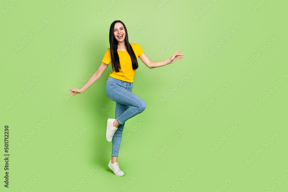 Full body portrait of gorgeous glad person enjoy free time toothy smile isolated on green color background Full body portrait of gorgeous glad person enjoy free time toothy smile isolated on green color background