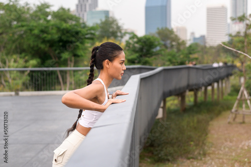A young fitness woman in sportswear exercising in city park  Healthy and Lifestyles.