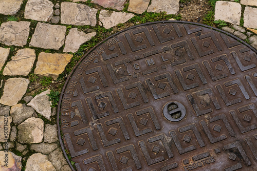 Metal manhole cover in the old town