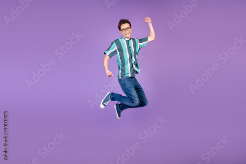 Full body profile side photo of young man jumper rejoice victory success isolated over violet color background