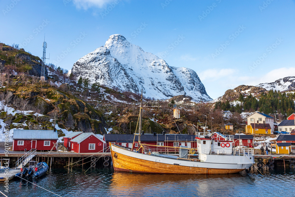 Nusfjord  Norway. 07-03-2022. Wooden Fishing boat  and colored houses at Nusfjord  harbor.