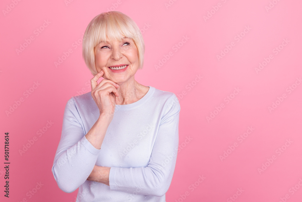 Photo of mature lovely woman wondered look empty space minded idea isolated over pink color background Photo of mature lovely woman wondered look empty space minded idea isolated over pink color background
