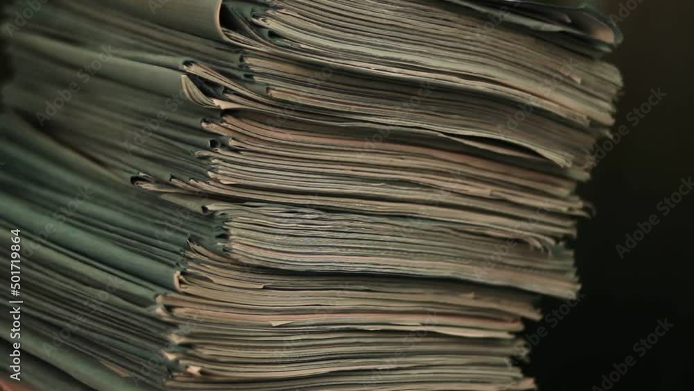 Close up of files, papers, newspapers in a stack on the desk. Close up of files, papers, newspapers in a stack on the desk.