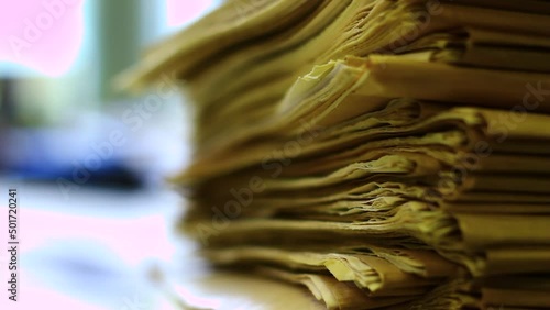 News paper, old files, papers in a big stack in the office.