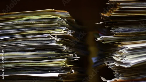 Old papers in the archive in a big stack.