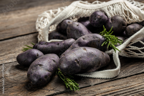 Organic purple sweet potato. Raw sweet potatoes or batatas. pomoea batatas. Batata potato. vegan food ingredient. banner, menu, recipe place for text, top view photo