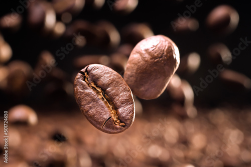 Fotografiet Roasted coffee beans flying. Macro shot.