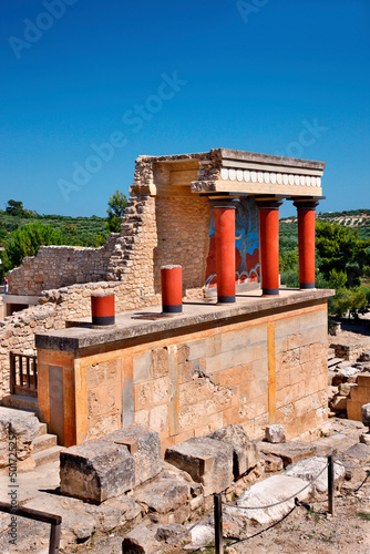 Partial view of the Minoan Palace of Knossos with characteristic columns and a fresco of a bull behind. Crete island, Greece.