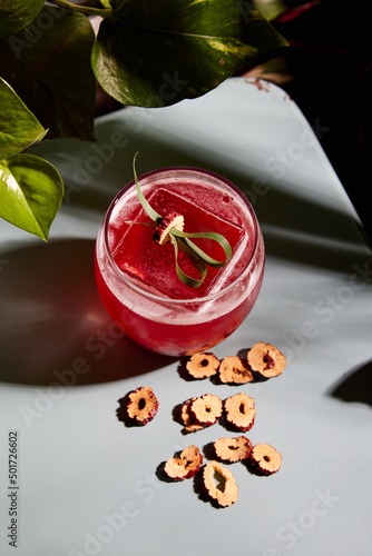 mixology red cocktail surrounded by plants