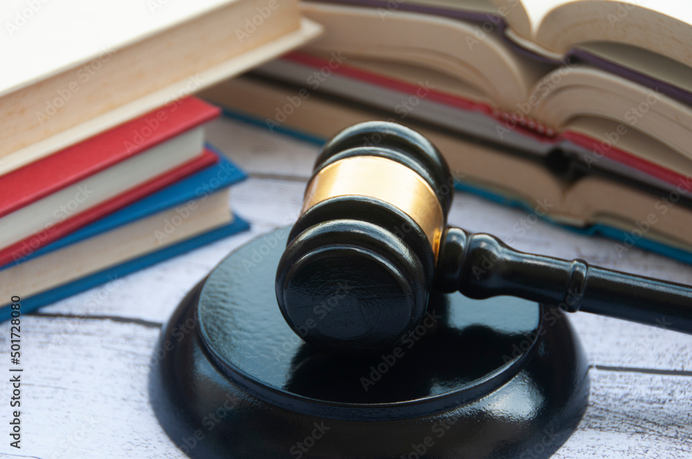 Lawyer gavel on wooden table with books background. Copy space and law concept Lawyer gavel on wooden table with books background. Copy space and law concept