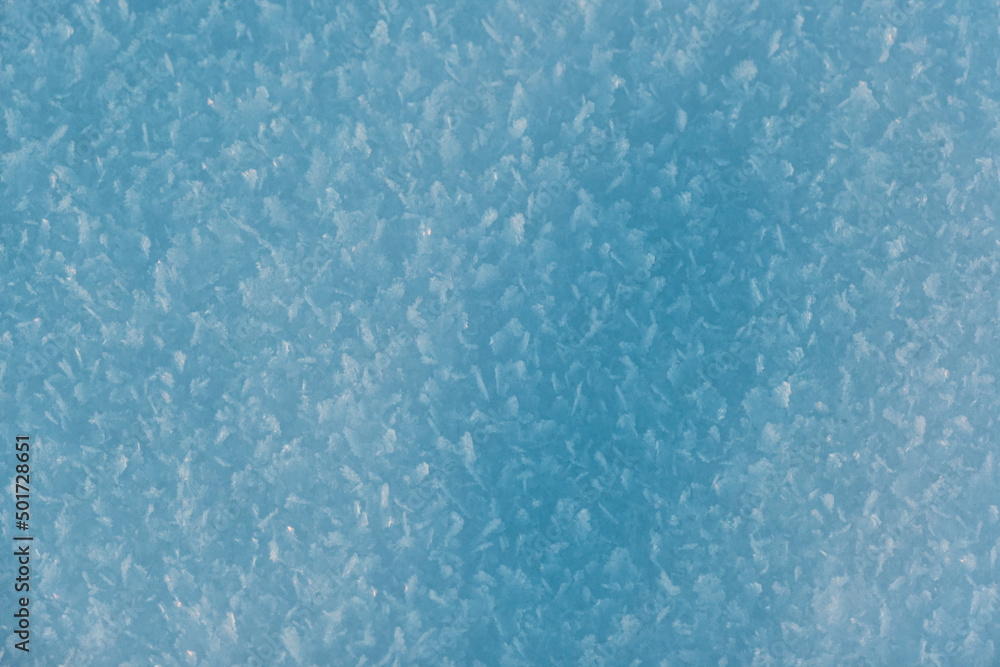 Snow texture with snowflakes close-up. Blue macro image of an abstract snowdrift. Crystal snow minimal texture pure. Winter landscape background. Snow texture with snowflakes close-up. Blue macro image of an abstract snowdrift. Crystal snow minimal texture pure. Winter landscape background.