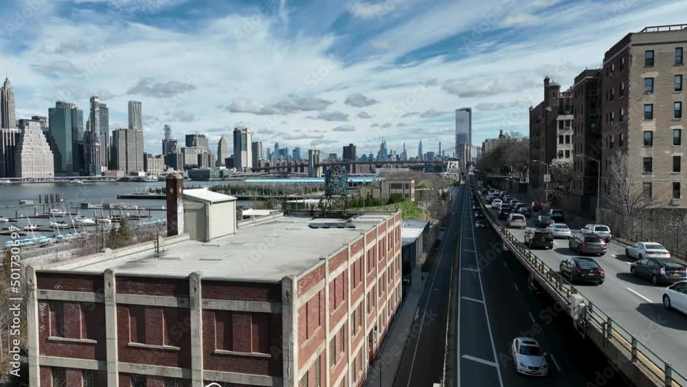 cars headed to Manhattan skyline in Dumbo Brooklyn colorful water tank Watertower New York City cars headed to Manhattan skyline in Dumbo Brooklyn colorful water tank Watertower New York City