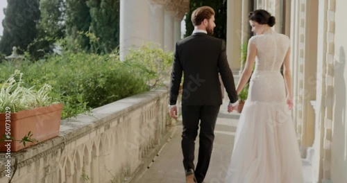 Young married couple walks on the balcony in Isola Del Garda.