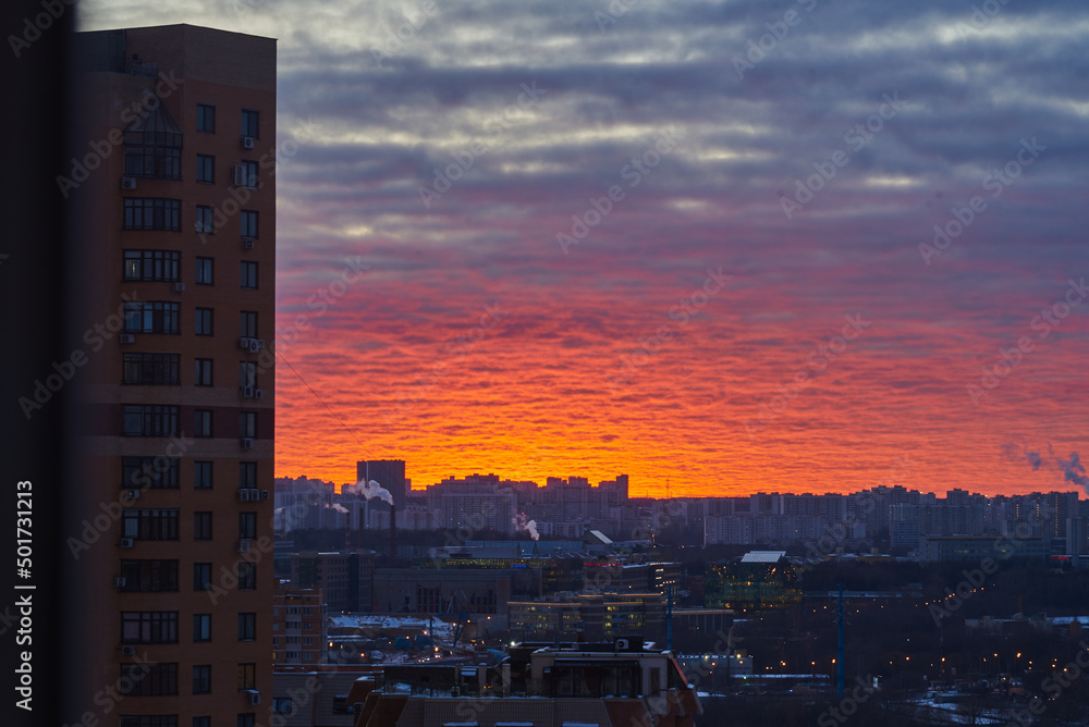 Fototapeta premium Urban landscape. A bright sunset over a winter city.