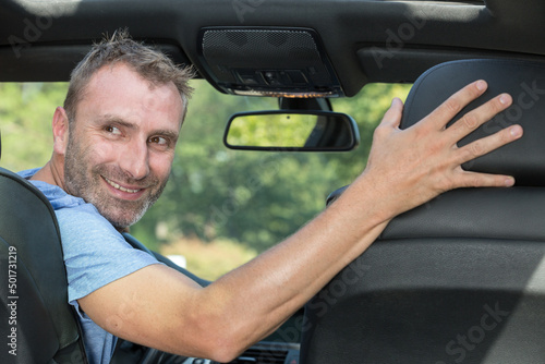 handsome man is driving in reverse
