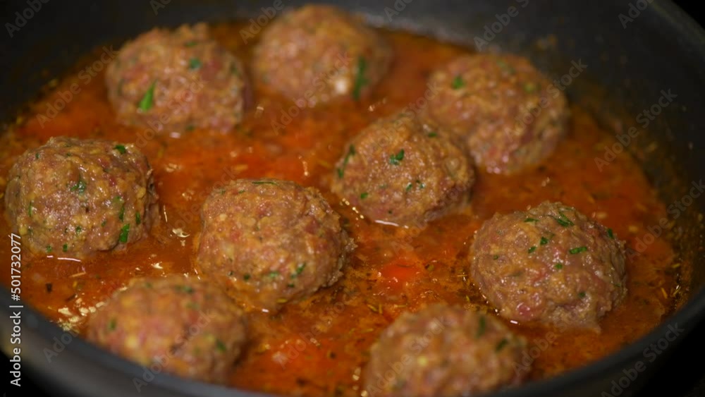 Cooking meatballs with tomato sauce in a pan . High quality 4k footage Cooking meatballs with tomato sauce in a pan . High quality 4k footage