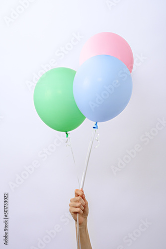 bunch of colorful pastel balloons in hand, element of decorations for birthday party, wedding, festival