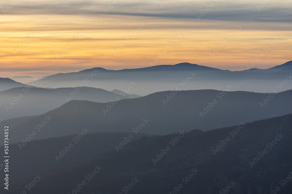 Stunning sunset over foggy Old mountain, Bulgaria. Landscape, travel concept.