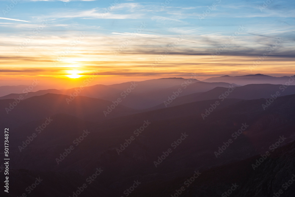 Fiery sunret over the foggy mountain. Landscape, travel concept.