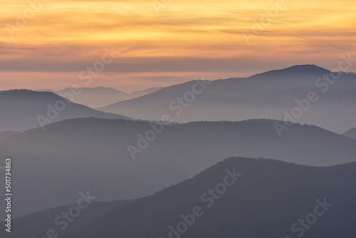 Stunning sunset over foggy Old mountain, Bulgaria. Landscape, travel concept. Close up view.