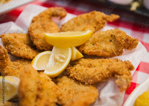 Fried prawns in breadcrumbs served with lemon wedges.
