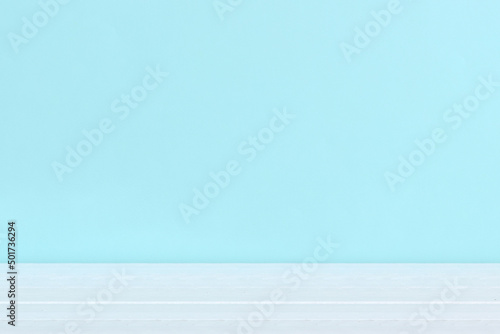 An empty wooden white table top and a light blue background. Abstract banner