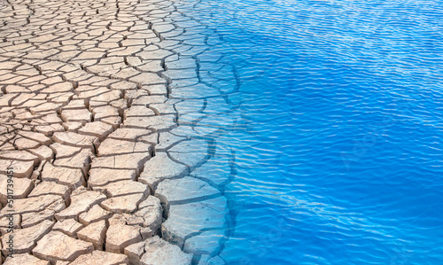 Cracked soil in blue water