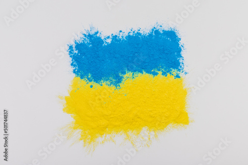 colorful Ukrainan flag yellow blue color holi paint powder explosion isolated on white background. russia ukraine conflict war freedom concept