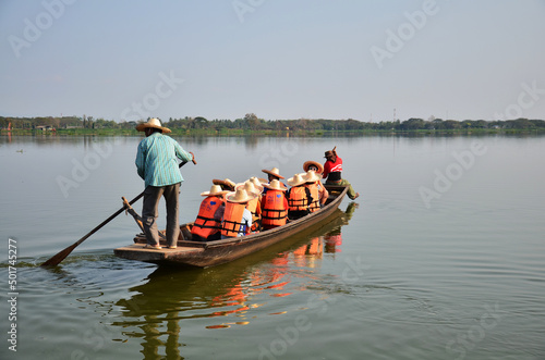 Guide local people paddle wooden boat bring thai and foreign travelers trip tour for travel visit at Kwan Phayao lake and large swamp freshwater and public park on April 30, 2011 in Phayao, Thailand