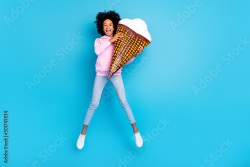 Fototapeta Full size photo of young girl have fun jump energetic holding big ice cream isol