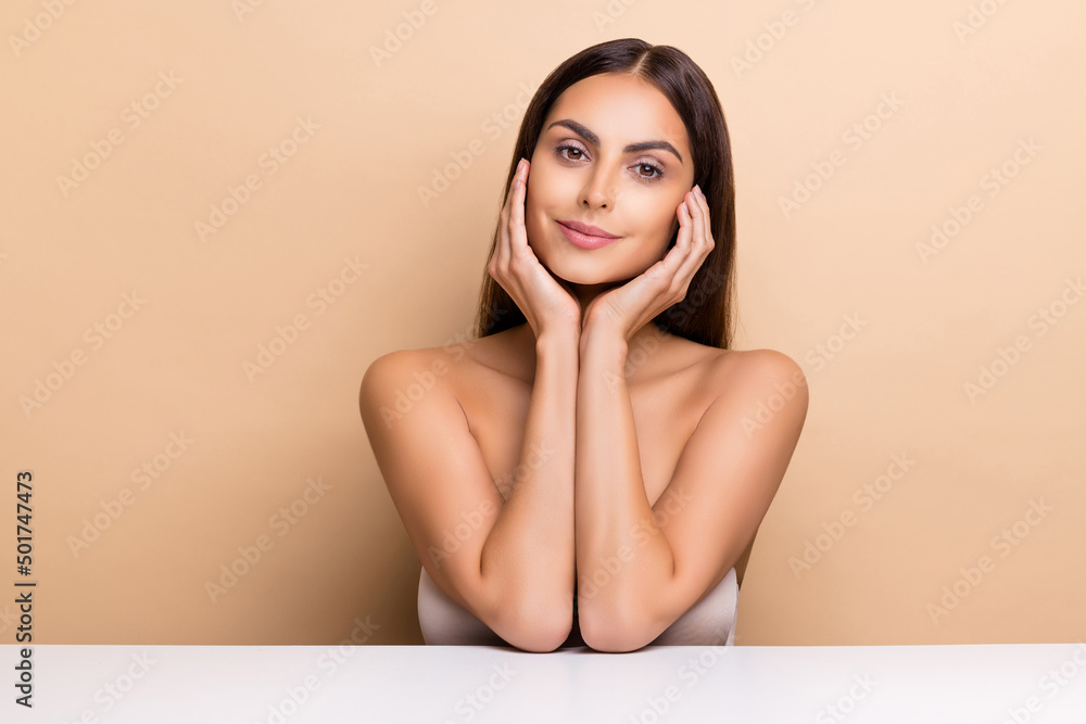Portrait of attractive sweet girl touching face enjoying healthy life medicine concept isolated over beige pastel color background Portrait of attractive sweet girl touching face enjoying healthy life medicine concept isolated over beige pastel color background