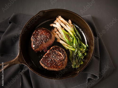 Aged Filet with Green Onions in a cast iron skillet