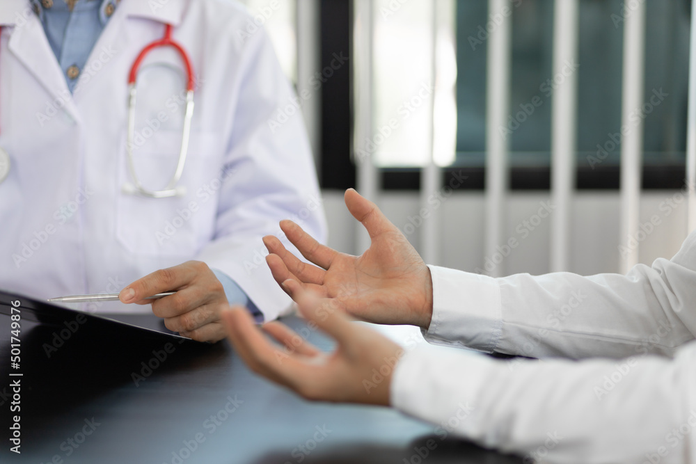 The doctor is conversation to the patient about the illness in the doctor's office and giving advice on health care. Concept of health problem consultation. The doctor is conversation to the patient about the illness in the doctor's office and giving advice on health care. Concept of health problem consultation.