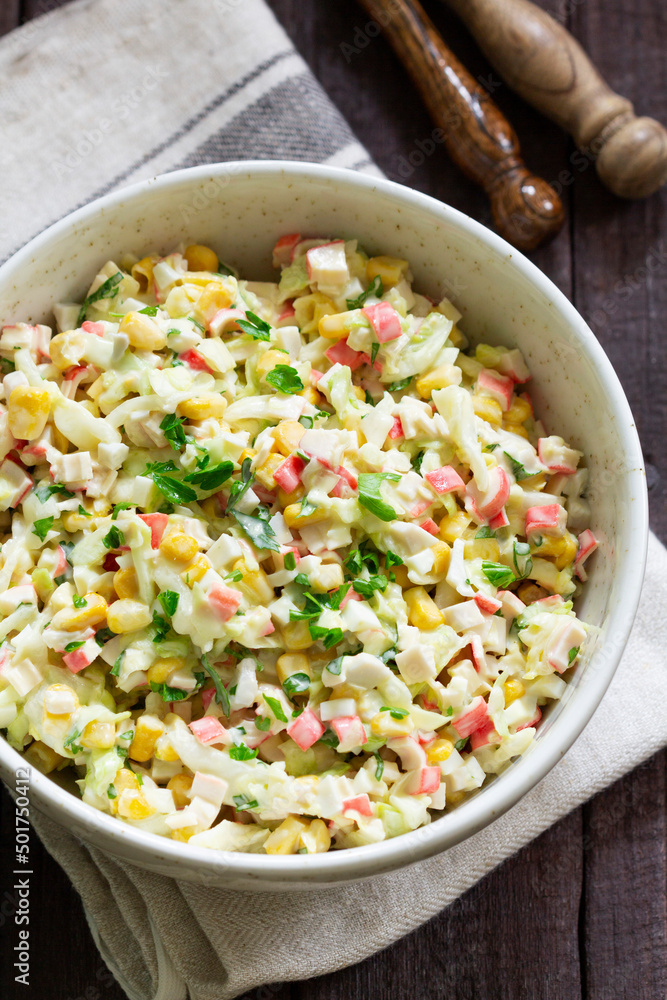 Vegetable salad with crab sticks, dressed with mayonnaise.