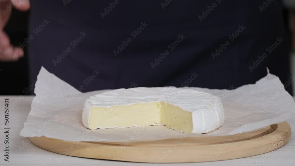 Camembert cream cheese closeup. Chef puts on table plate with