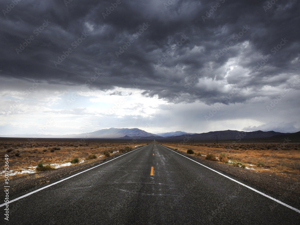 Storm clouds looming over the remote desert, above State Highway 266.  A desolate route of vast wilderness that takes you across the Nevada - California Border. 