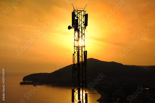 Wallpaper Mural Amazing closeup sunset drone view of silhouette of cell tower. Wireless connection. Spectacular view of cellular tower with mountains and sea in the background. 5G network. Torontodigital.ca