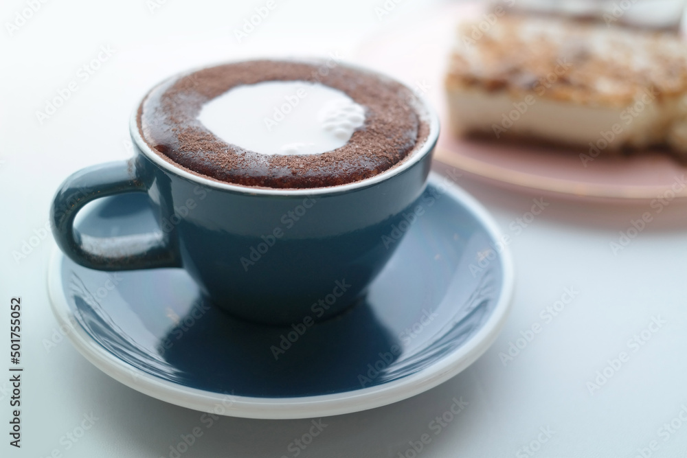 Coffee and cake with foam in a mug Coffee and cake with foam in a mug