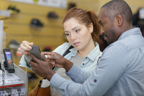 friendly hardware store assistant helping female customer