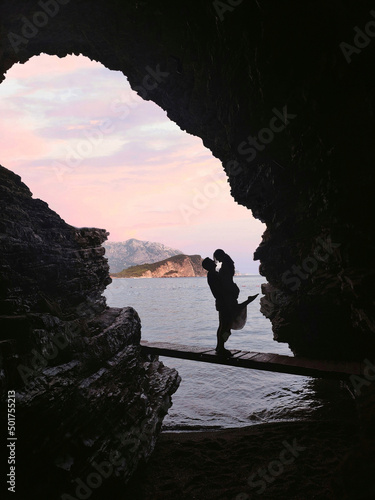 Wallpaper Mural Silhouette of couple in a cave in front of a beautiful seascape on Mogren beach Torontodigital.ca