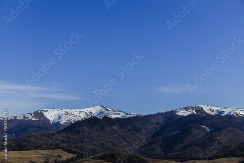Fototapeta Naklejka Na Ścianę i Meble -  Mountains with snow and blue sky at daylight.