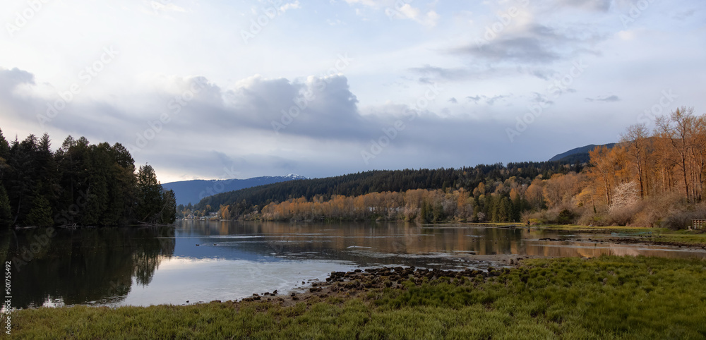Panoramic View of a Canadian Landscape in Shoreline Trail, Port Moody, Greater Vancouver, British Columbia, Canada. Park in a Modern City during a colorful Sunset Sky. Nature Background Panorama