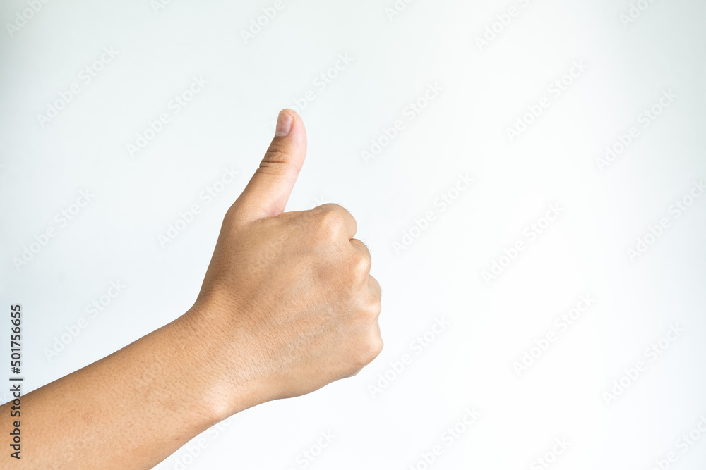 Closeup of asian male right hand showing thumbs up sign against white background