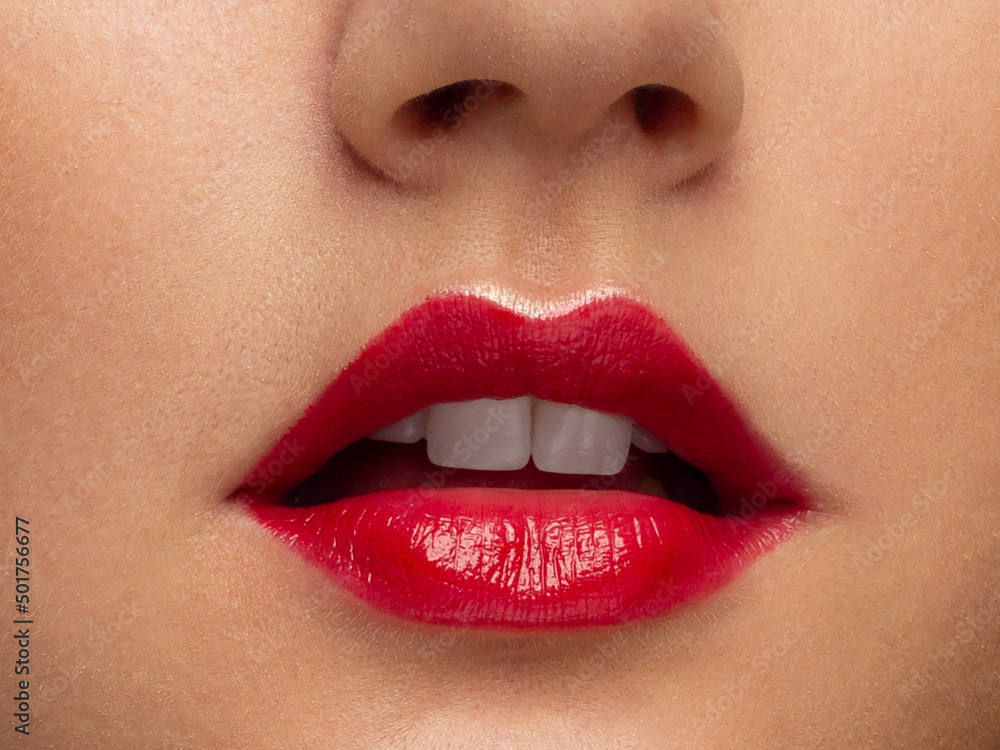 Fototapeta premium Perfect red lips makeup. Close up macro photo with beautiful female mouth. Plump full lips. Close-up face detail. Perfect clean skin, light fresh lip make-up. Beautiful spa tender lip