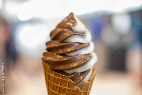 Vanilla and Chocolate Ice cream with waffle cone. blur background.
