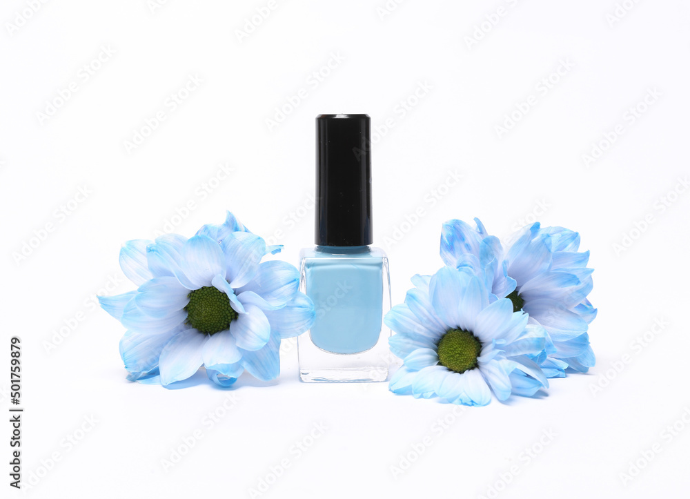 Beauty still life. Blue Nail polish bottle with blue flowers isolated on white background Beauty still life. Blue Nail polish bottle with blue flowers isolated on white background