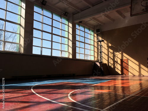 School university college sports hall with huge big windows and sun coming inside. Sun shadow reflection on the walls, Colorful sunny weather. photo